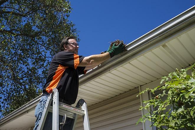 a technician repairing a gutter system in Center Line MI